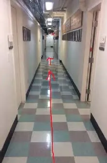 Hallway with arrows indicated where to walk