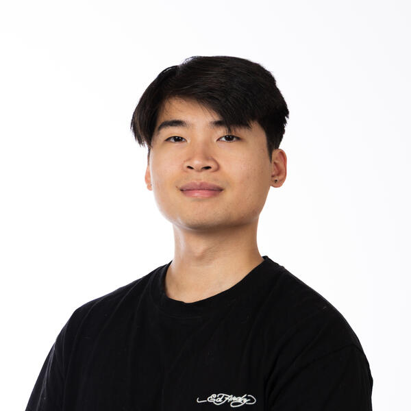 Human with black hair in a black shirt.