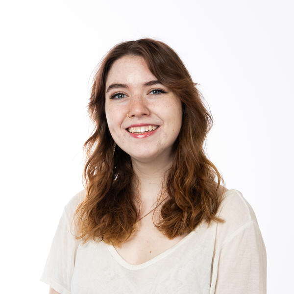 Human with ginger hair and a white shirt.